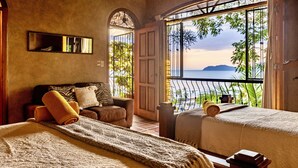 A bedroom with a large window, a bed, a sofa, and a view of the ocean. - Ocean View 🌅Infinity Pool Villa & Hot Tub !CLOSE TO BEACH! (Jaco Beach)