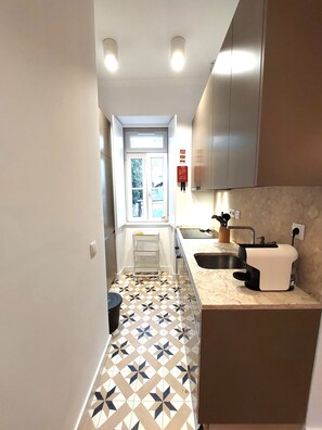 Une cuisine moderne avec un sol à motifs, une fenêtre et un évier.