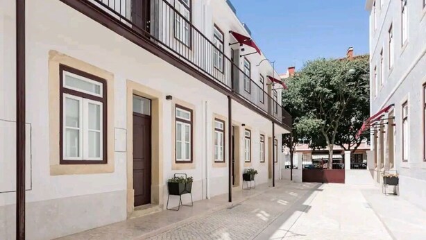 Una hilera de edificios tradicionales de estilo europeo, con diseños de ventanas y balcones uniformes.