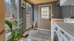 A kitchen with a wooden ceiling, a stove, a sink, and a window with a view of the outdoors. - 🔥hot tub, view, 🐕 friendly modern cabin (New Market)
