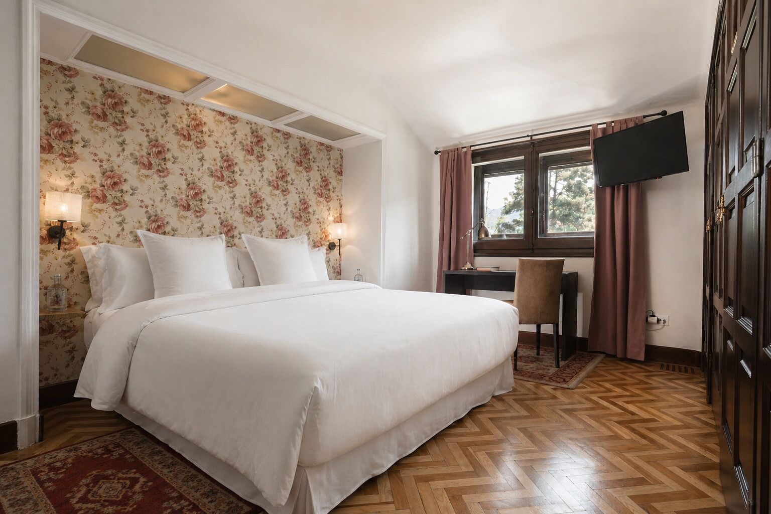 A hotel room with a bed, desk, chair, TV, and a window with curtains.