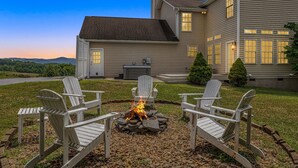 A house with a fire pit in the backyard surrounded by Adirondack chairs. - Castlewood Retreat | Views, Hot Tub & Foosball Table🛁🏔️ + Biltmore Pass (Alexander)