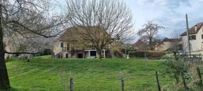 A house with a stone facade, a large tree in front, and a grassy yard. - Beautiful character home with a view of the river   (Liourdres)