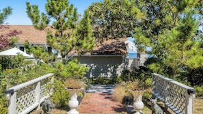 Stroll along the garden pathway to the charming house with a welcoming front porch.