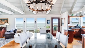 Enjoy expansive ocean views from the large windows and dine at the central table with comfortable benches.