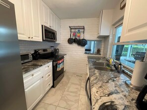 Fridge, microwave, oven, stovetop - Waterfront 3‑bedroom home with heated pool on a deep sailboat‑access canal. Features EV charging, garage, and stocked kitchen. Near Downtown Punta Gorda, Fisherman’s Village, Isle Yacht Club, and PGD airport. (Punta Gorda)