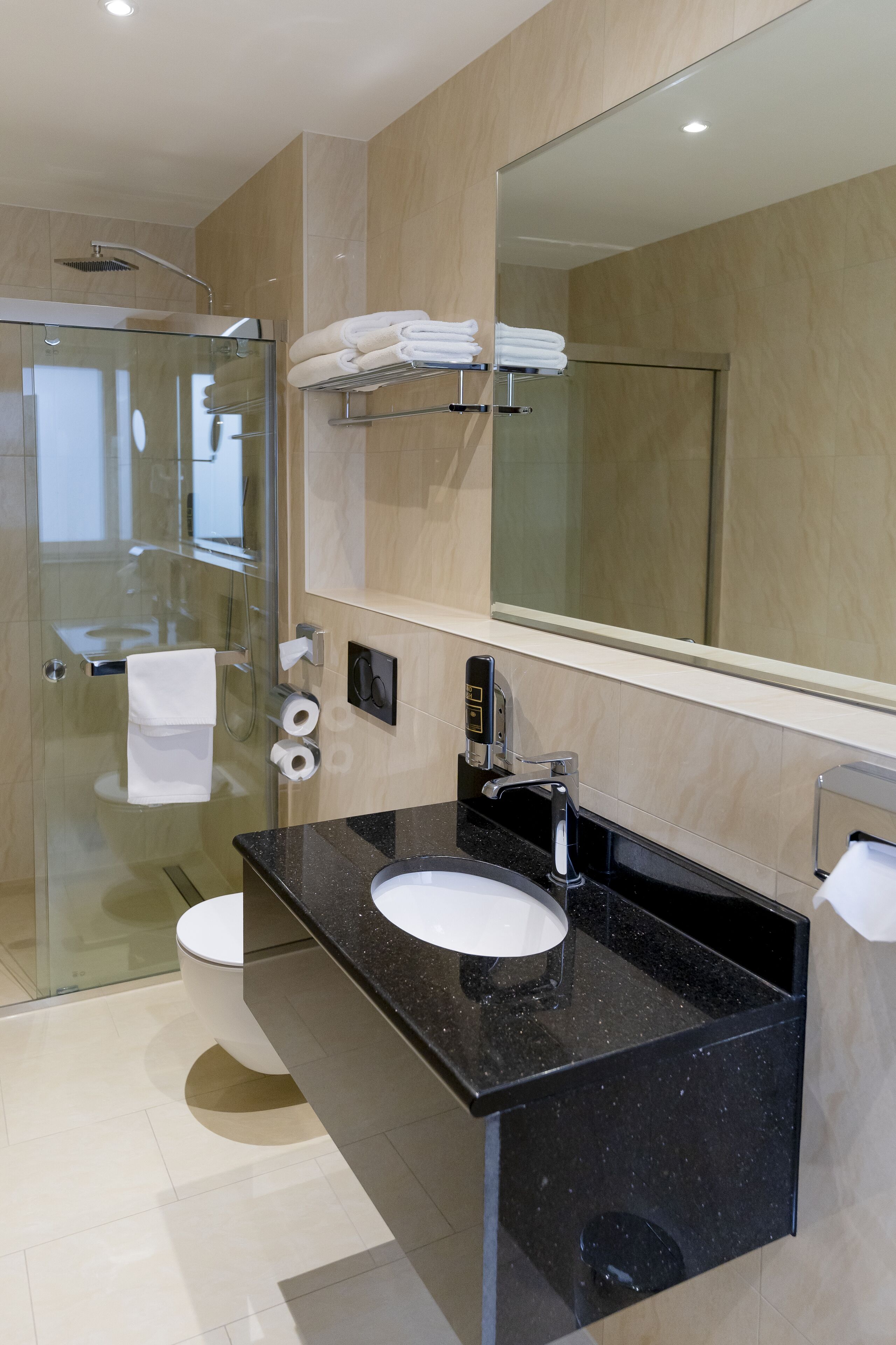 business quadruple room | bathroom | rainfall showerhead, hair dryer, towels, soap