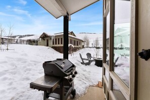 Guests can enjoy al fresco dining with a barbecue grill in this outdoor space.