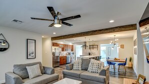 A modern living room with a gray sofa, a coffee table, and a ceiling fan. - South Scottsdale Poolside Getaway! (Scottsdale)