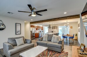 Relax in this stylish living area with a comfortable sofa, coffee table, and dining space.