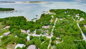 An aerial view of a coastal residential area with houses, a dock, and boats. - Lake views from The Byrd House (Pottsboro)