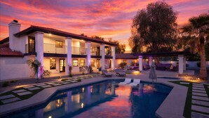 A two-story house with a swimming pool, outdoor seating, and a sunset sky. - Paradise Palace-Heated Pool/Spa-Guest House & More (Scottsdale)
