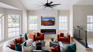 A living room with a fireplace, two sofas, a coffee table, and a television. - Paradise Palace-Heated Pool/Spa-Guest House & More (Scottsdale)