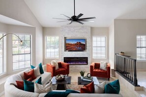 A living room with a fireplace, two sofas, a coffee table, and a television. - Paradise Palace-Heated Pool/Spa-Guest House & More (Scottsdale)