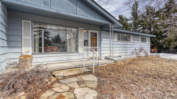 A single-story house with a stone pathway leading to the front door.