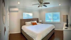 A bedroom with a bed, ceiling fan, two windows with blinds, and a TV on a stand. - Bright 2 Bedroom Cozy HOUSE! Pasadena/Alhambra Prime Location! Dogs OK! (Alhambra)