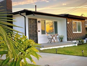 Enjoy outdoor dining or relaxation on the front porch, surrounded by a well-maintained lawn.