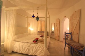 A four-poster bed with a canopy, a wooden chair, and a small table. - 2042 Elegant Villa with Garden, heated Pool and Spacious Layout (Marbella)