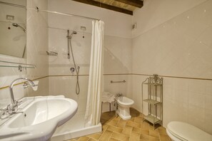 Tina con regadera, secadora de cabello, bidet, toallas 