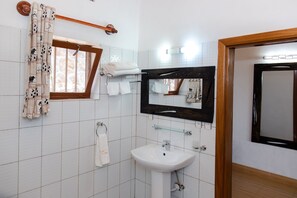 A bathroom with a white sink, a mirror, and a window with a curtain. - Serene Lake View Lodge in Kayove, Rwanda (Kayove)