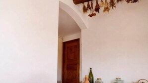 A staircase leading to a door, a large vase, and various containers on a shelf. - Sunny holiday home in Provence with pool (Séguret)