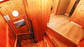 A wooden sauna with a sloped floor leading to a bench area. - Vacation home Dorine by Interhome (Nendaz)
