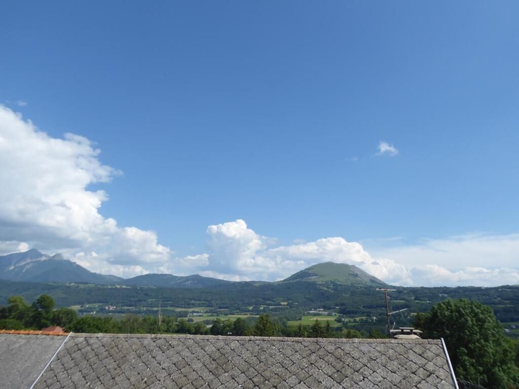 A view of a mountainous landscape with a clear sky.