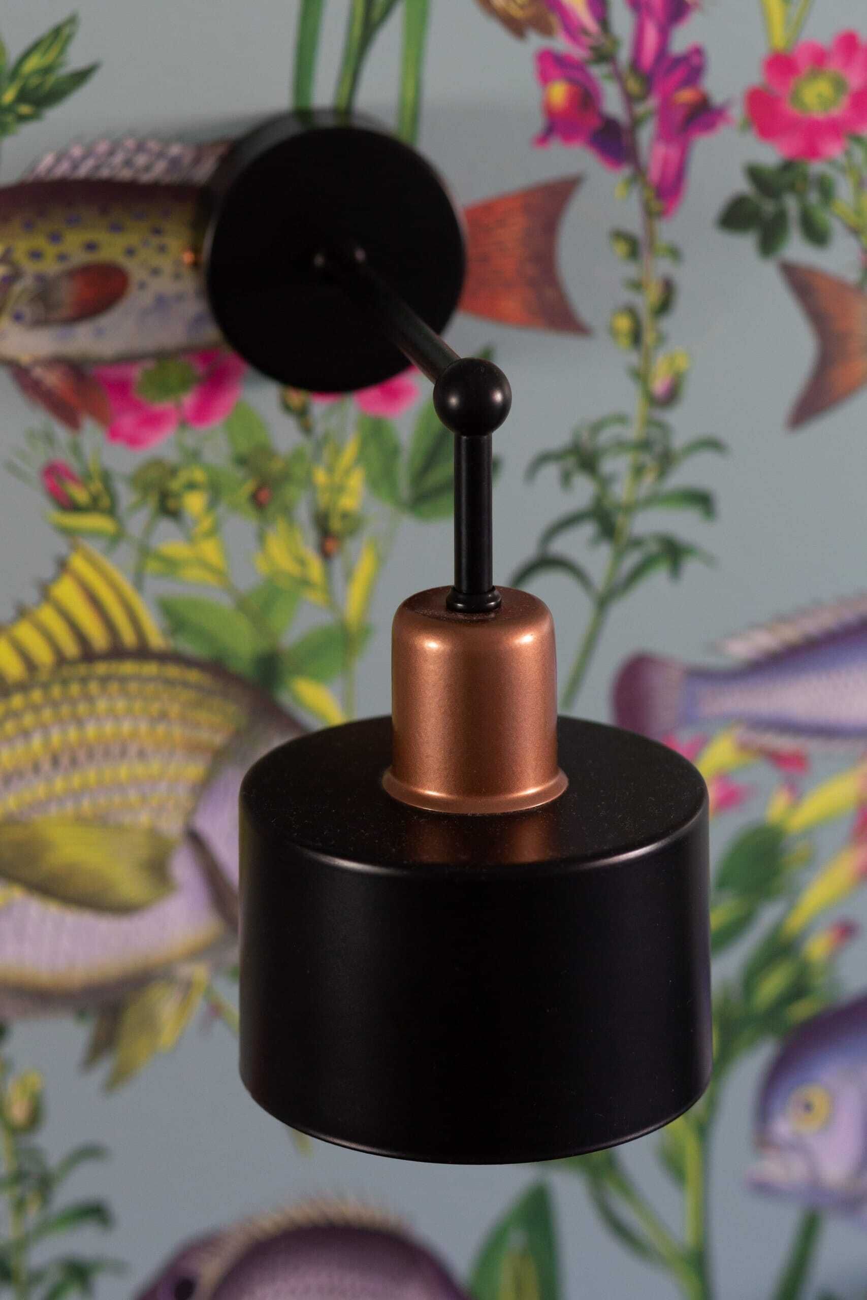 A black and copper hanging lamp with a black shade and a copper base.