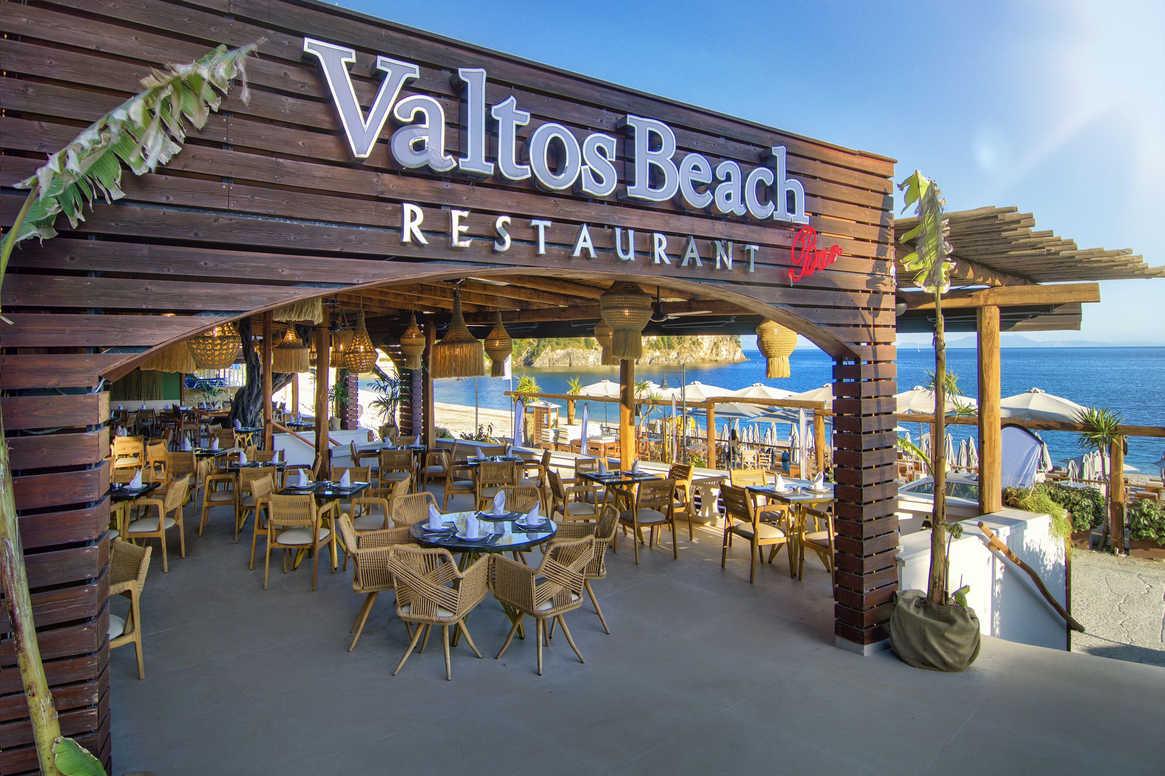 A restaurant named 'Valtos Beach' with outdoor seating and a view of the ocean.