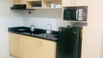 Fridge, microwave, electric kettle, cookware/dishes/utensils