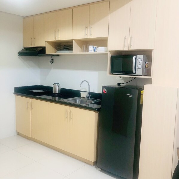 Fridge, microwave, electric kettle, cookware/dishes/utensils - New One Bedroom Big Condo with Balcony In the Center of The City (Quezon City)