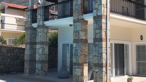 A two-story house with a stone facade, a swimming pool, and a red roof. - Villa Ayshella , Luxury Ovacik Villa with stunning mountain views and sunsets (Ovacık)