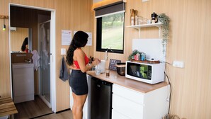 A compact kitchen with a microwave, a sink, and a small countertop.