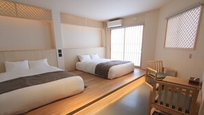 A hotel room with two beds, a wooden bench, and a small table. - KONJAKUSO Osaka Tempozan "IKESU" Projection Mapping SPA "TAKADORO" Wheel View (Osaka)