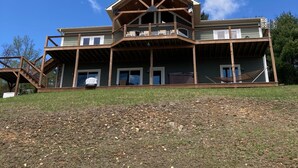 A two-story building with a wooden deck and a balcony.