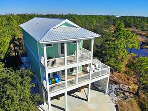 Enjoy expansive views of the surrounding landscape from the two-story beachfront property's spacious balcony.