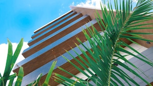 A modern building with horizontal wooden slats and a white facade. - Heart of Cozumel w/ Rooftop Pool DC 501 (San Miguel de Cozumel)