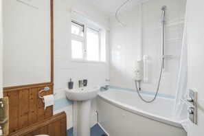 Combined shower/bathtub, towels, toilet paper