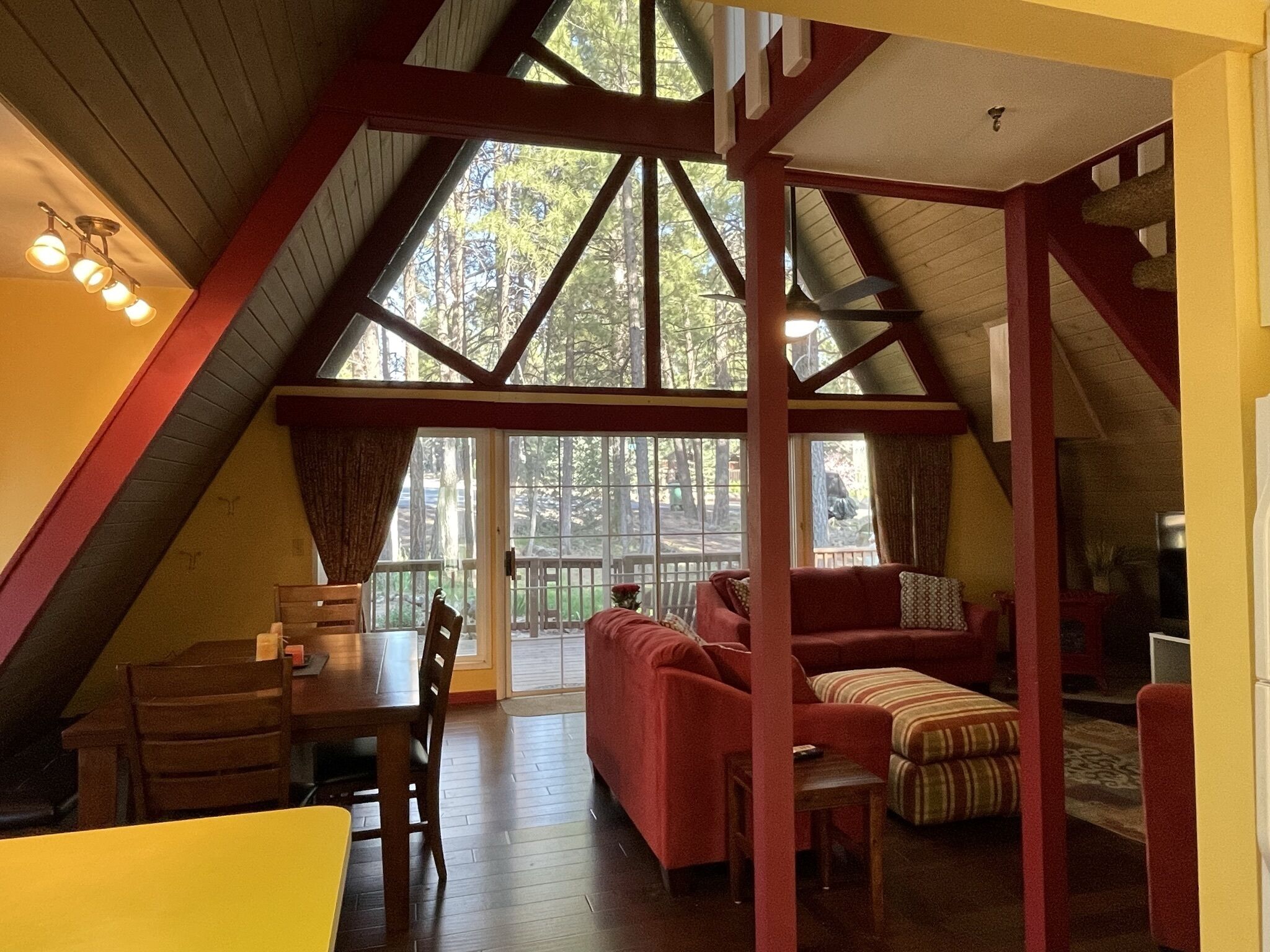 NEW LISTING! Cozy A-Frame nested in pine trees, huge window and wrap-around deck