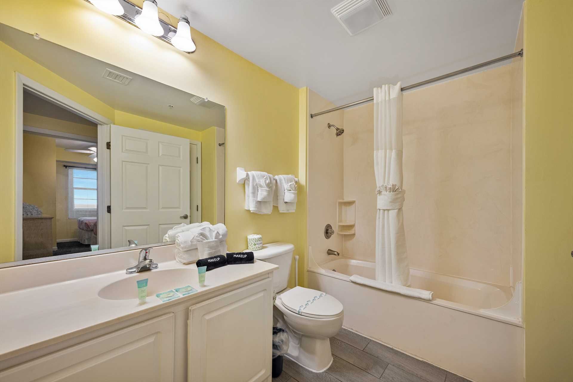 A bathroom with a sink, toilet, and shower.