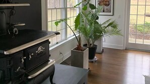 A modern kitchen with a large stove, a potted plant, and a framed picture on the wall. - Private Country Getaway (Bedford Hills)