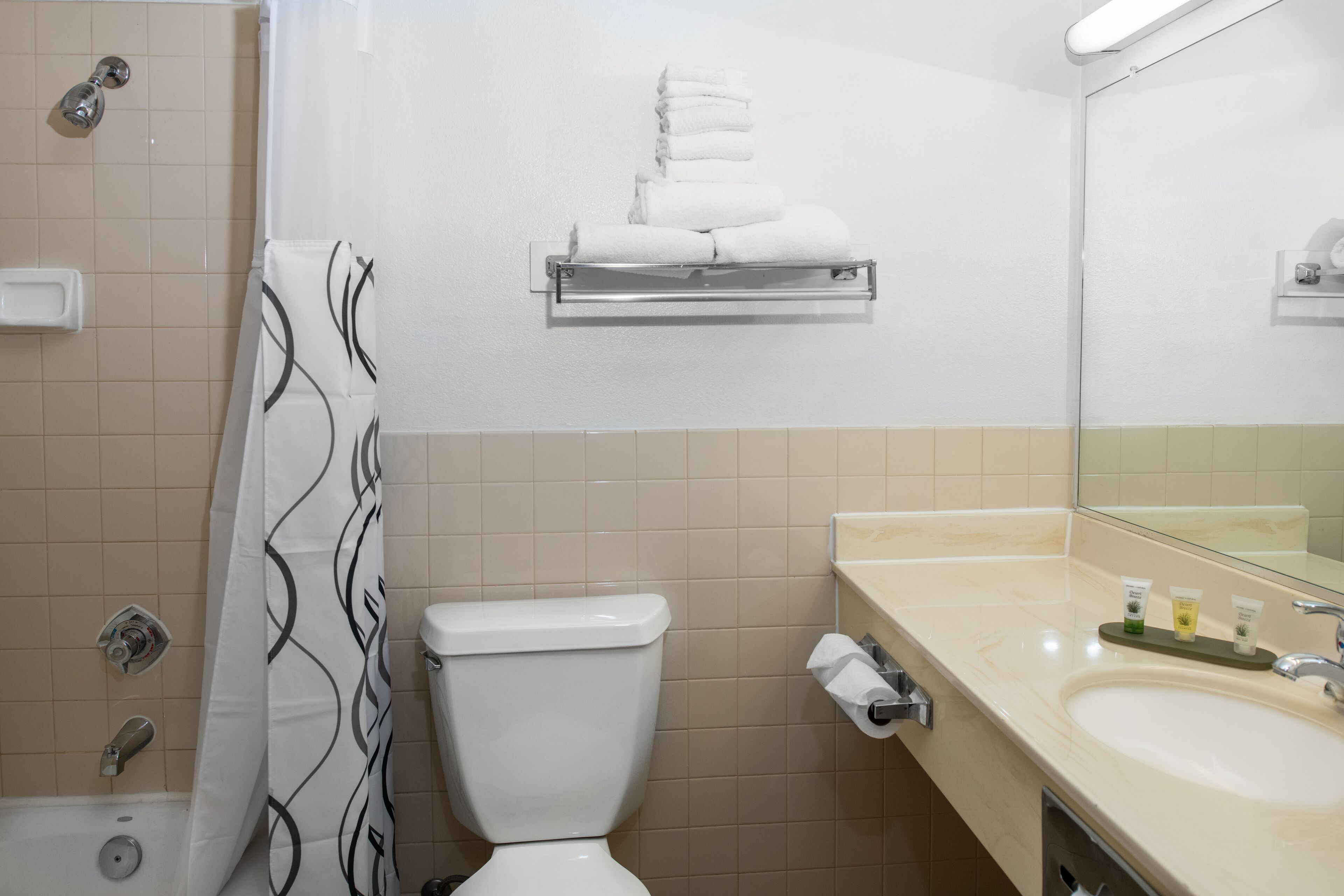 separate bathtub and shower, towels, soap, shampoo