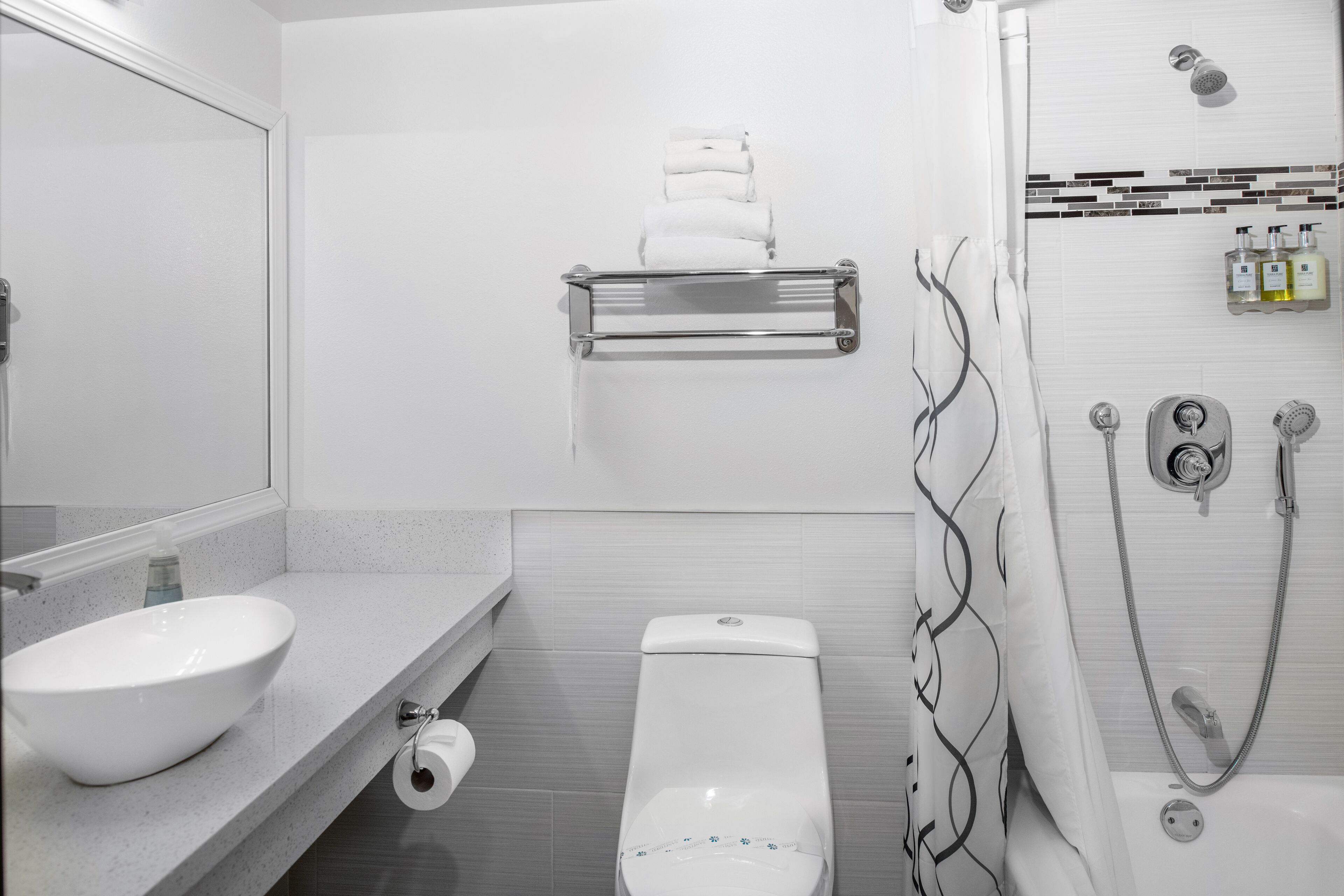 separate bathtub and shower, towels, soap, shampoo