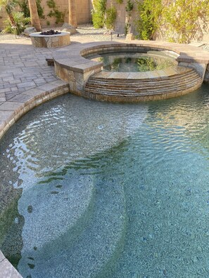 A stone pool with a stone edge and steps leading into the water. - RELAX:  Saltwater Pool & Spa, Pool Table, Darts (Indio)