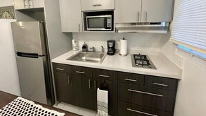 A modern kitchen with stainless steel appliances, a built-in microwave, and a gas stove.