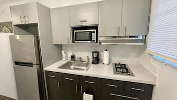 Microwave, coffee/tea maker, cookware/dishes/utensils, dining tables