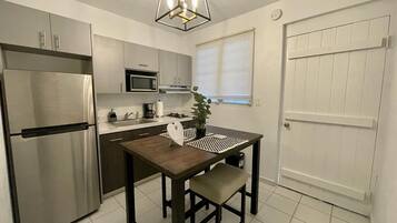 Microwave, coffee/tea maker, cookware/dishes/utensils, dining tables