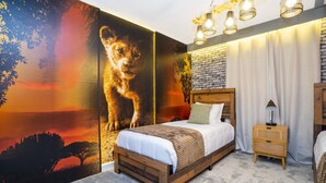 A bedroom with a large mural of a lion, a wooden bed, a nightstand, and a brick wall.