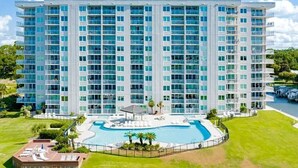 A multi-story hotel with a swimming pool and a well-maintained lawn. - Best Views in Orange Beach!!  (Orange Beach)