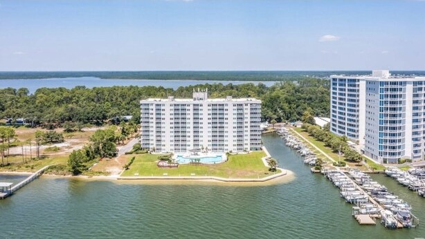 A waterfront hotel with multiple high-rise buildings, a marina, and a dock. - Best Views in Orange Beach!!  (Orange Beach)